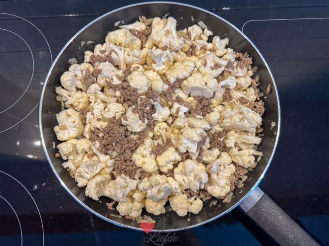 Voeg de bloemkool toe en smoor zachtjes beetgaar